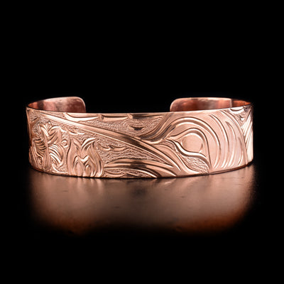Hand-carved copper cuff bracelet depicting swordfish watching a sea star in a seaside setting. By Kwakwaka’wakw artist Cristiano Bruno.