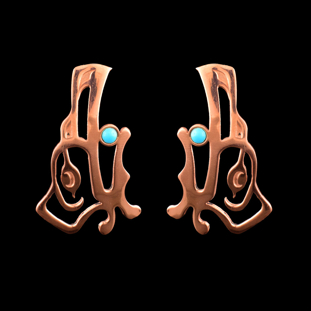 These handcrafted Raven drop earrings feature intricate formline of the Ravens face in a warm copper finish, accented by a vibrant turquoise stone.
