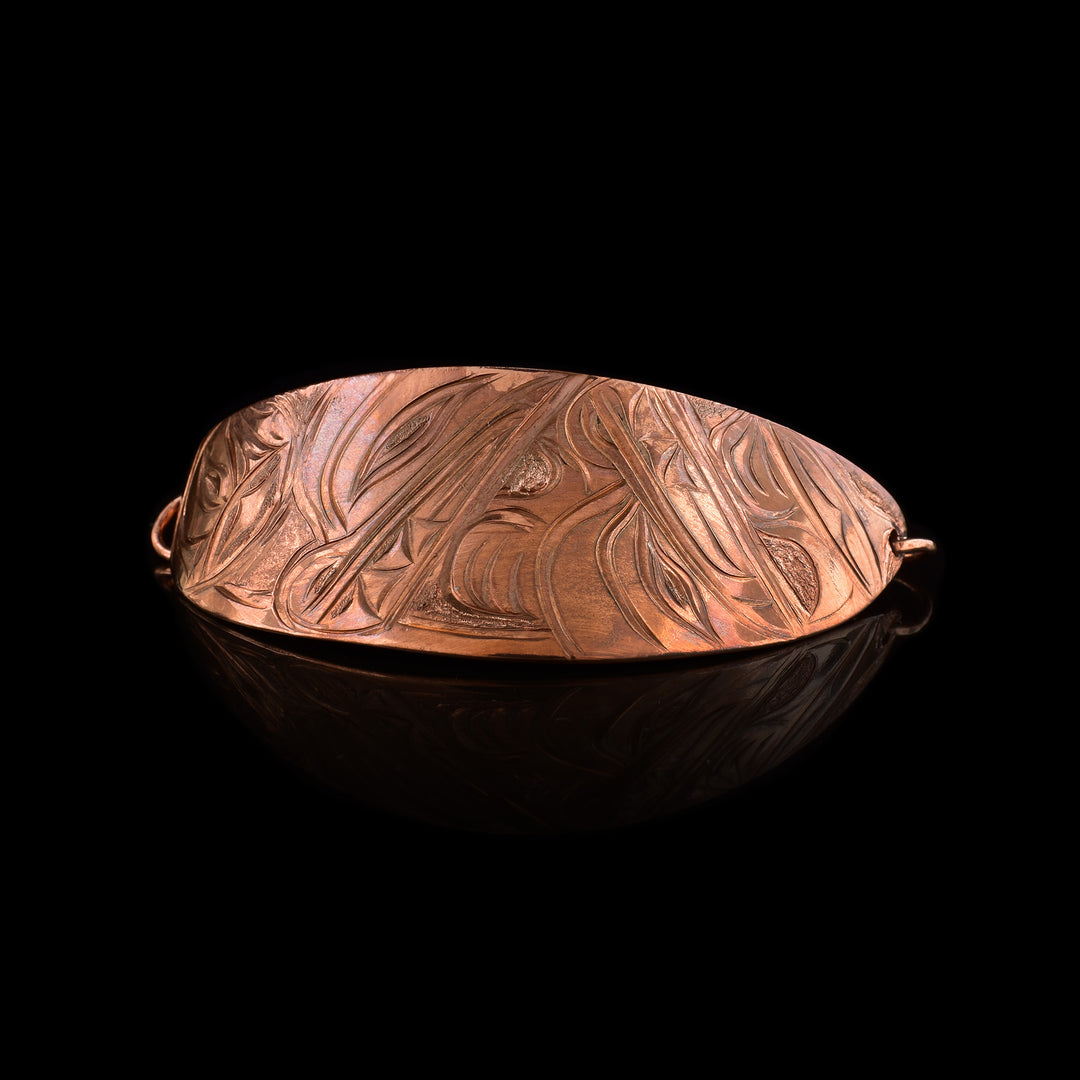 Hand-carved Copper Wolf Couple under the moon Hair Tie by Kwakwaka'wakw artist Cristiano Bruno. This oval accessory features the legend of the wolf, made of copper.