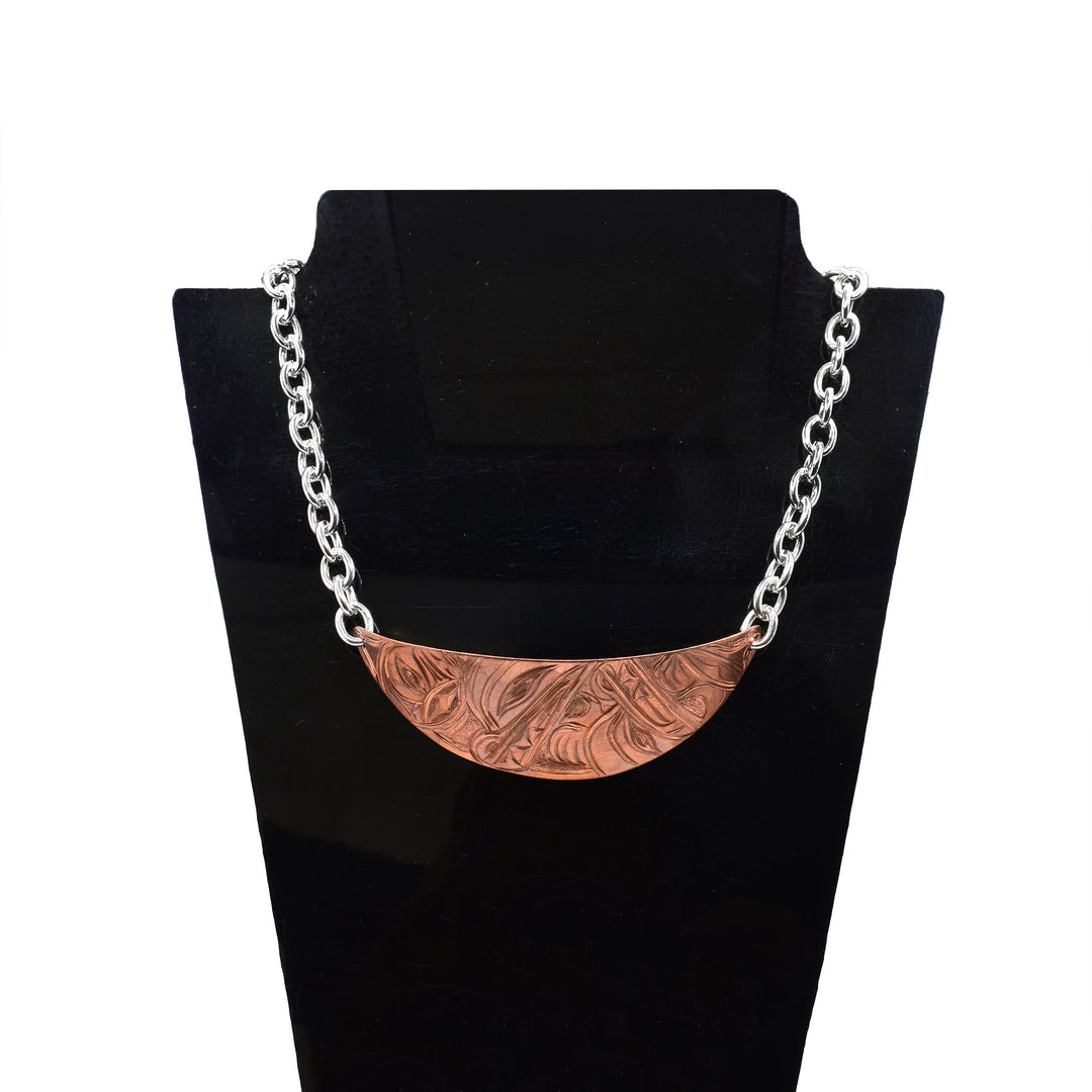 Make a statement with this wide copper necklace, beautifully engraved with the traditional Wolf and Moon legends. Paired with a sterling silver chain, the contrasting metals create an elegant two-tone design that is both comfortable to wear and visually striking.