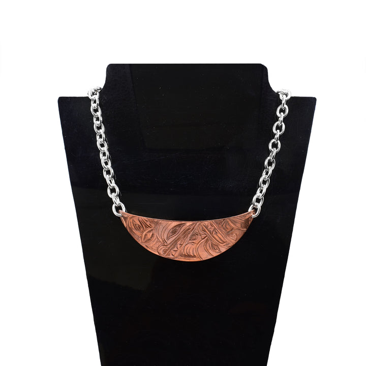 Make a statement with this wide copper necklace, beautifully engraved with the traditional Wolf and Moon legends. Paired with a sterling silver chain, the contrasting metals create an elegant two-tone design that is both comfortable to wear and visually striking.
