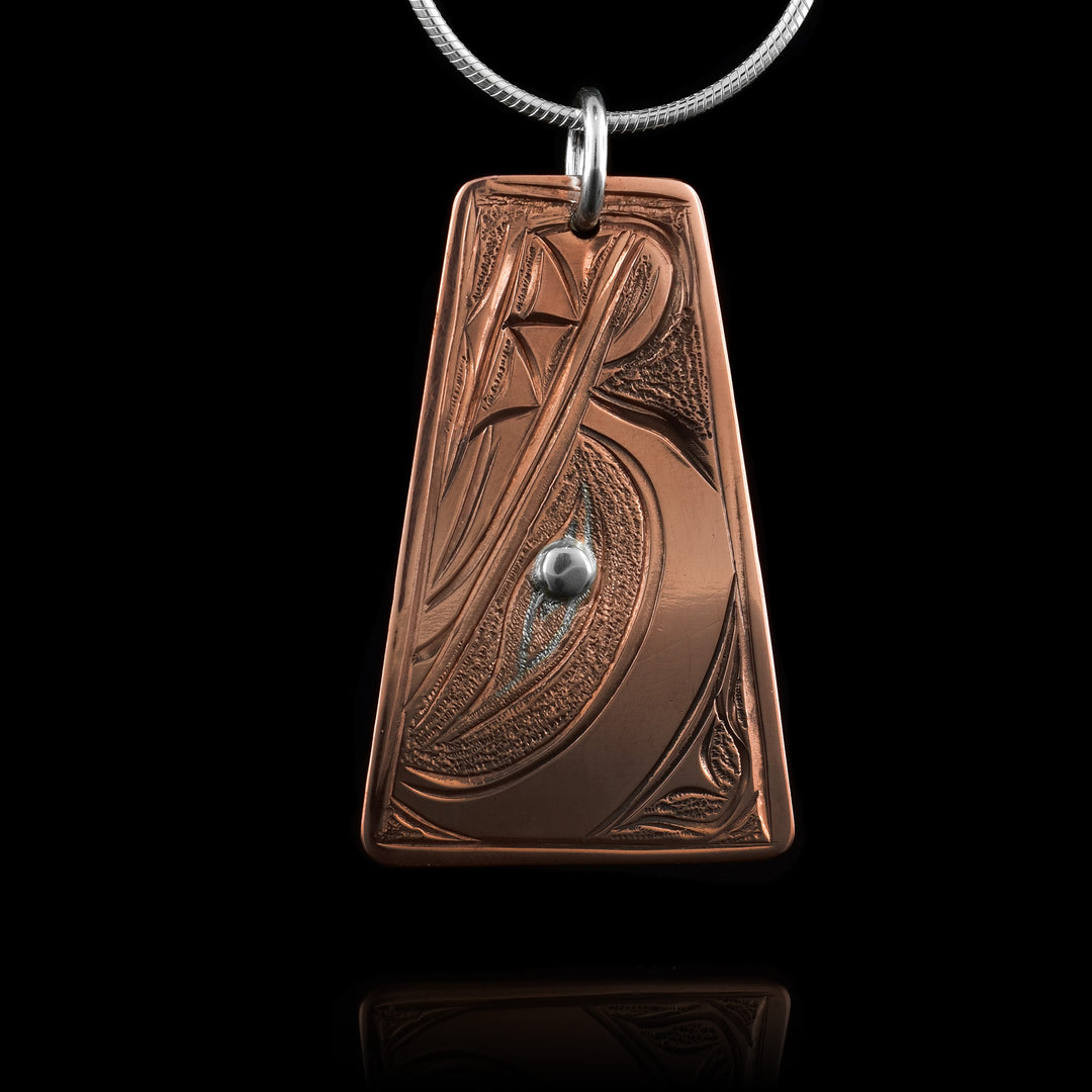 This handcrafted trapezoid copper wolf pendant by Kwakwaka’wakw artist Cristiano Bruno features bold Indigenous carving and a silver inlay eye for striking contrast.