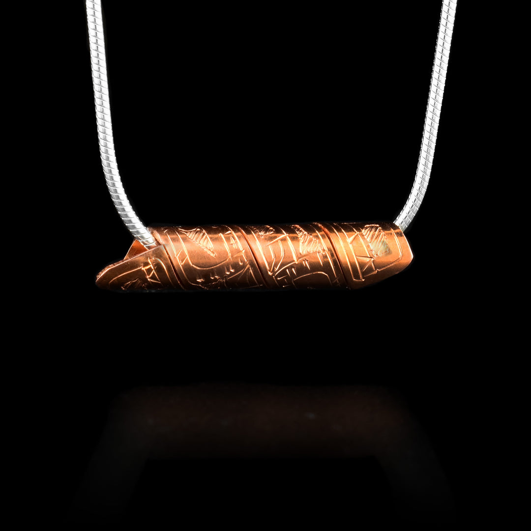 This spiral cylinder pendant is made from a single, copper band that has been twisted into a cylinder. There is depiction of the Wolf legend carved into the surface of the band so it appears on the outside of the cylinder. It is shown at a side profile with its head, eye and mouth at one end on the rest of its body behind it.