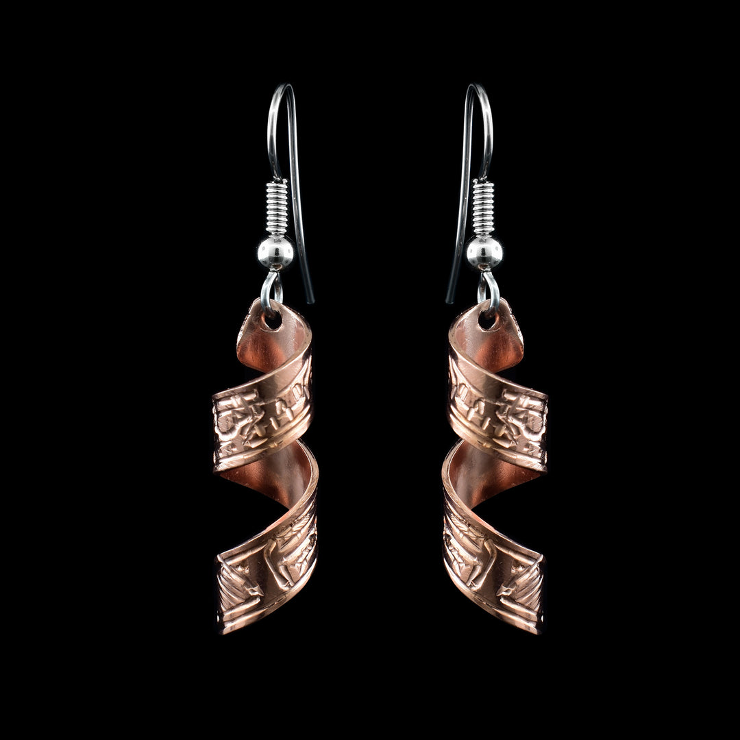 These spiral earrings have hangs made from copper bands that have been curved into horizontal spirals. The copper cylinders drop down and there is a depiction if the Wolf carved into the outside of the bands. The head of the wolf is facing the top of the piece.