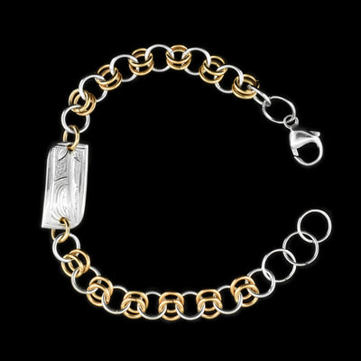 This silver and gold link bracelet is made from sterling silver and 14K gold fill. This piece has a silver and gold fill chain with a rectangle charm at the top. There is a depiction of the Hummingbird carved into the surface of the silver charm.