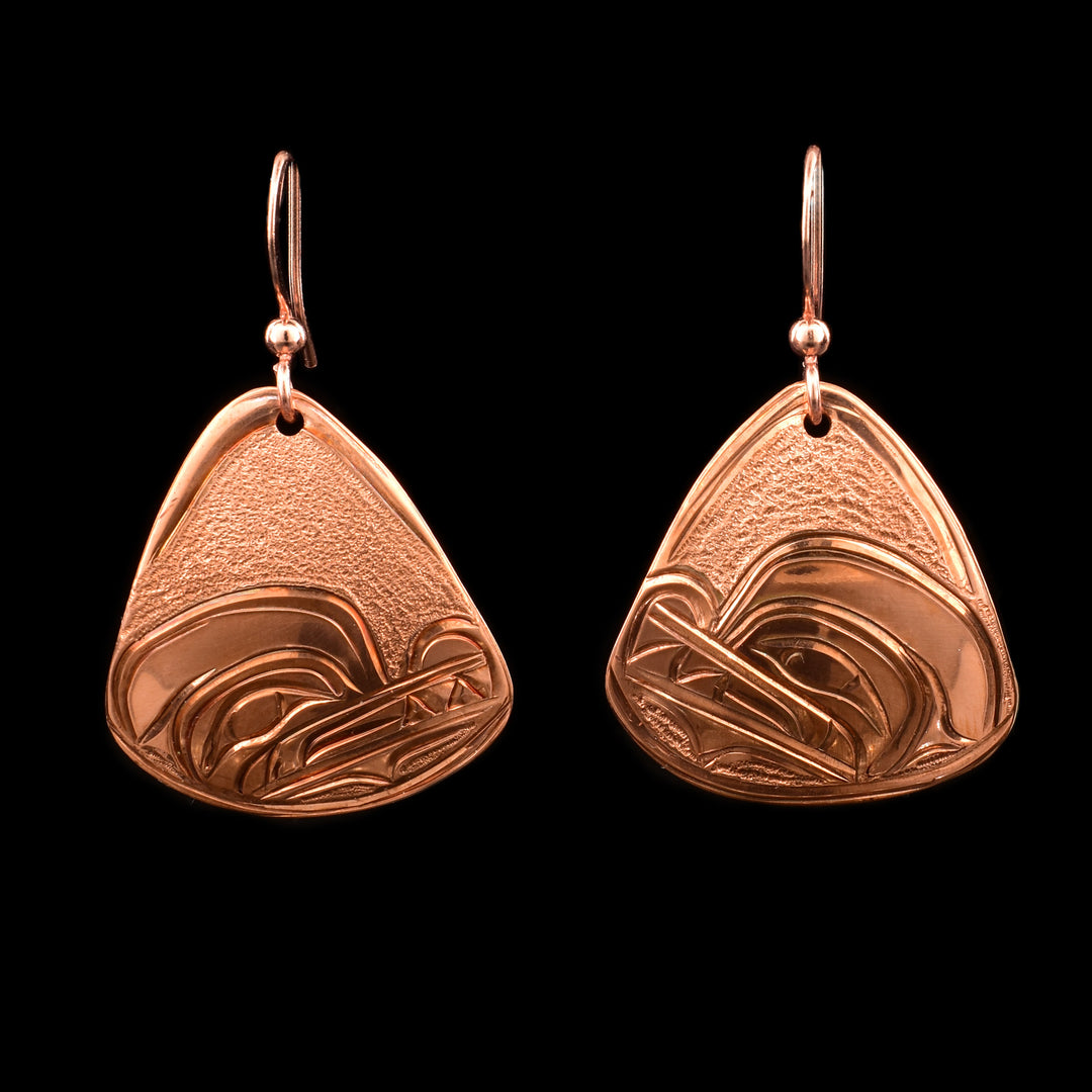 These dangling Wolf earrings are made from copper and have rounded, triangle shaped hangs. There are carvings on the surface of the hangs depiction the Wolf.
