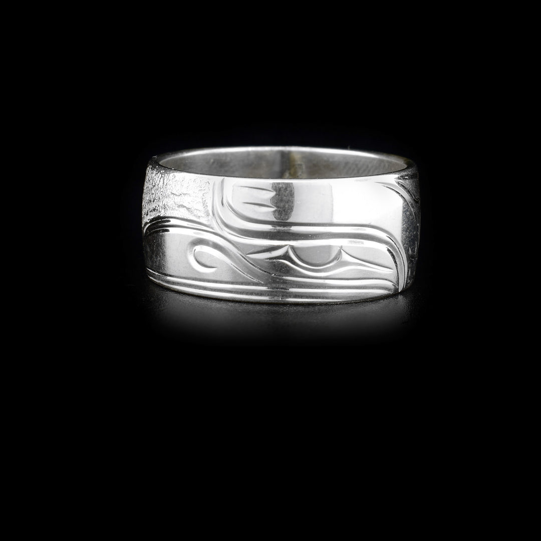 This silver band ring is made from sterling silver and has a depiction of the Raven carved into it.