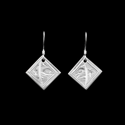 These dangling Moon earrings are made from sterling silver and have small, diamond shaped hangs. There are depictions of the Moon carved into the surface of the hangs.