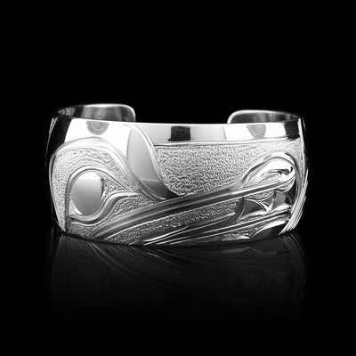 This Wolf bracelet cuff has been made using sterling silver and has a single, wide band with a gap in the back. There is a fabulous depiction of the Wolf that has been intricately carved into the surface of the band. There is a textured, dimpled designs that have been made around the Wolf.