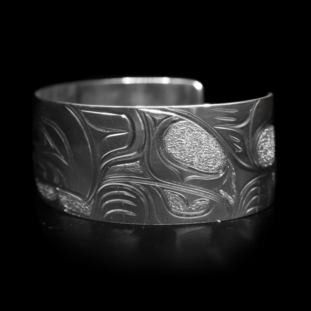 This sterling silver wide cuff bracelet has a full depiction of the Wolf beautifully carved into the surface of the band.