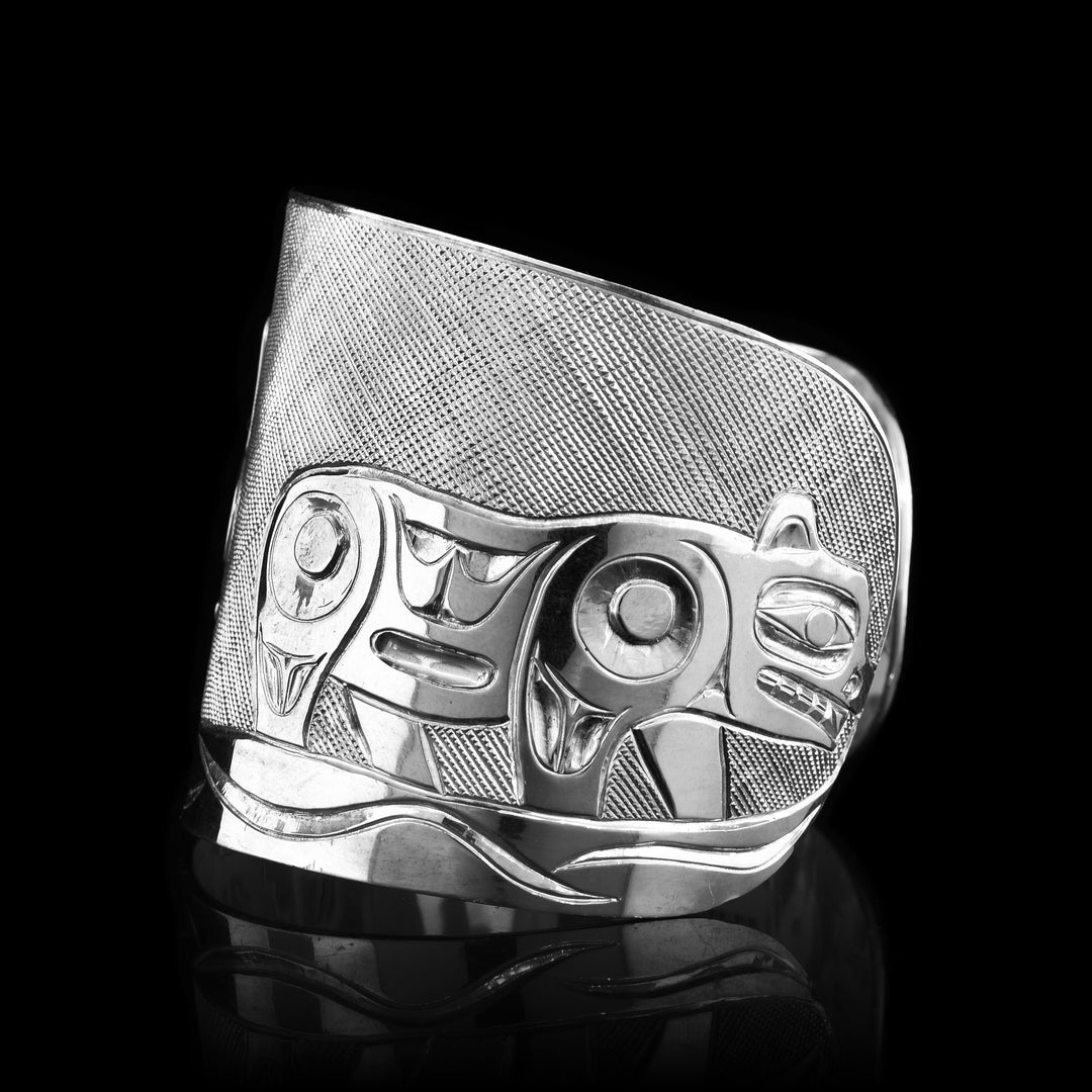 Sterling silver carved cub on the side of the bracelet.