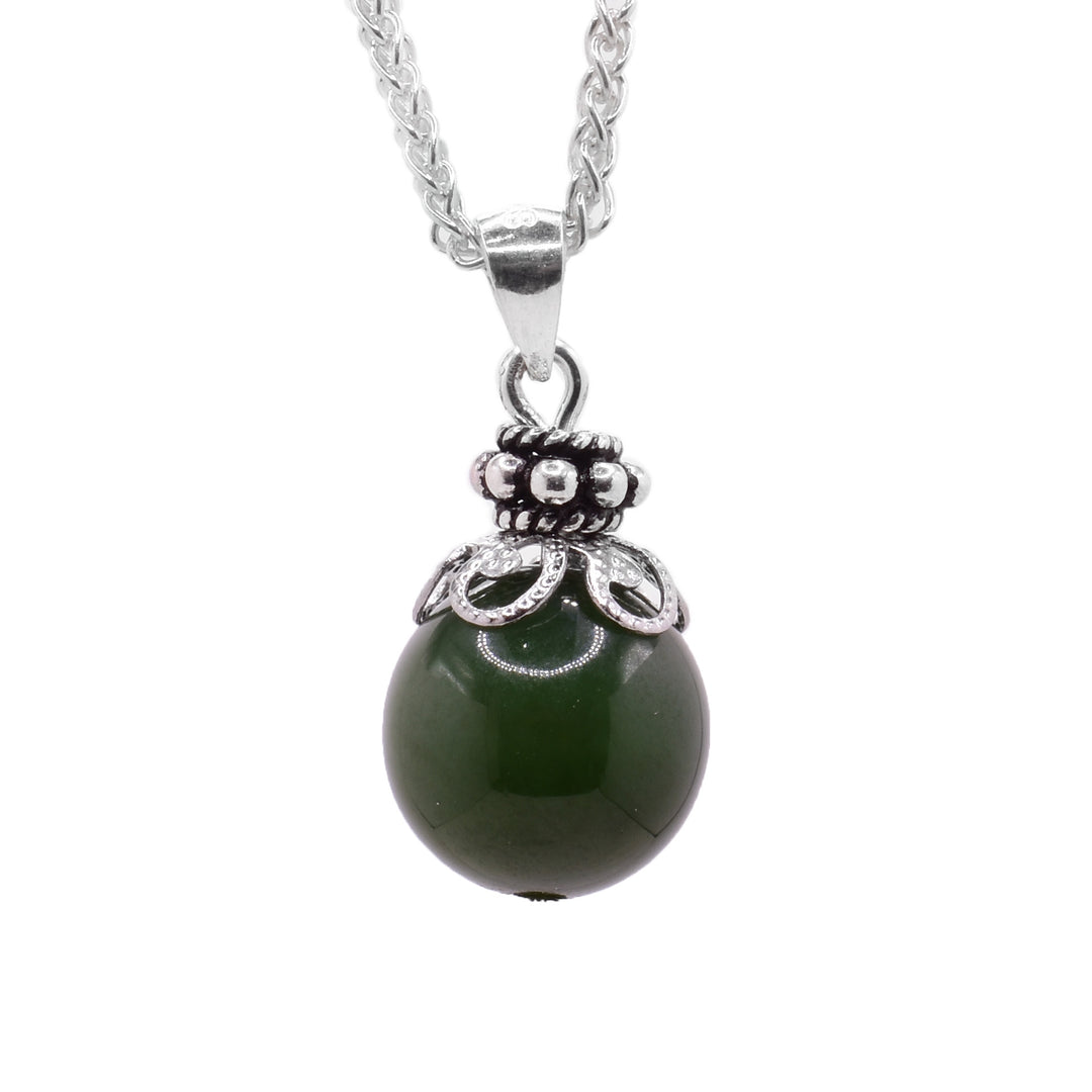 Round BC jade bead with boho accents. Metals are stainless steel and sterling silver. Handcrafted by an in-house artisan.