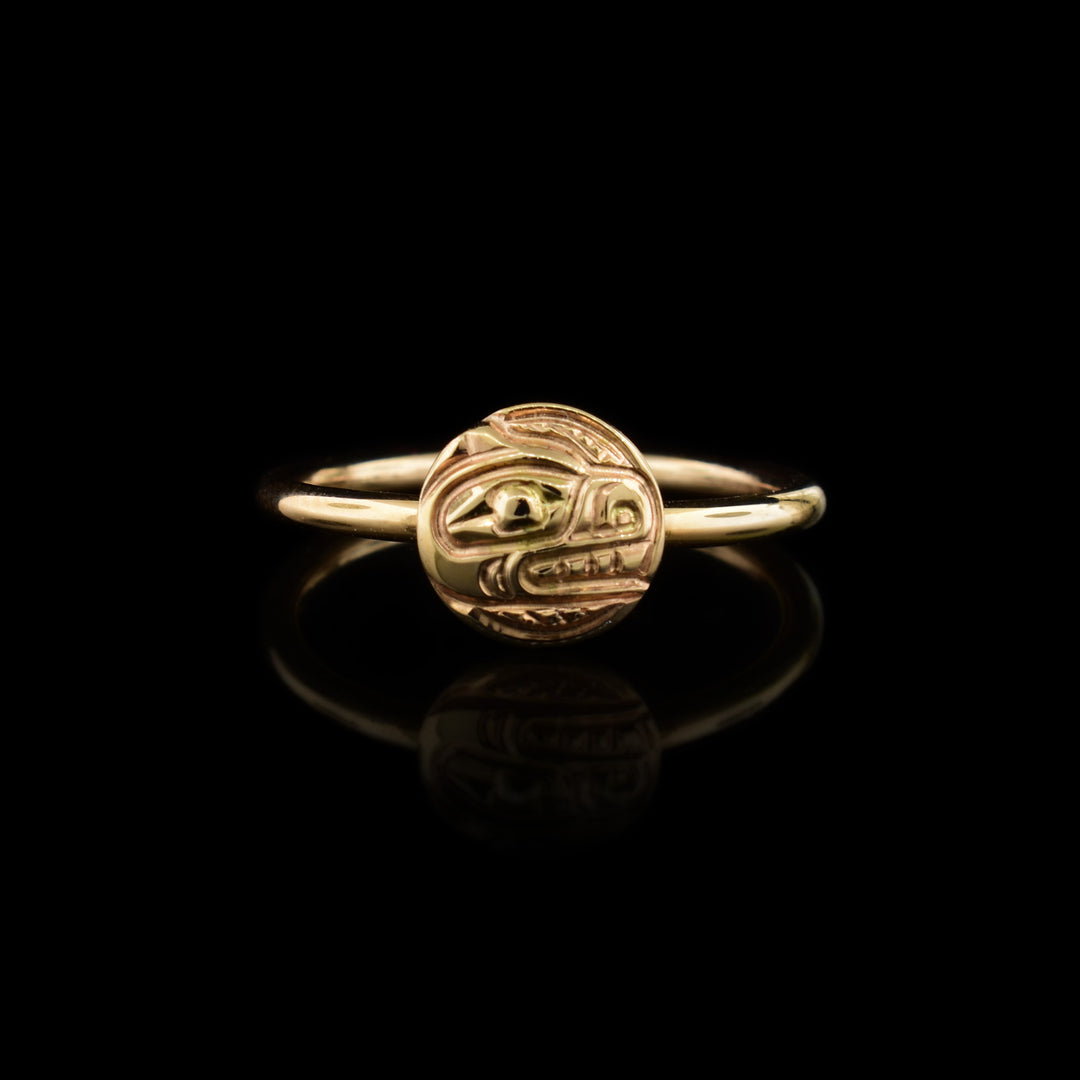 This 14K gold ring has a thin band with a circular frame in the center depicting the head of a Bear facing to the right. The details on this Bear signet ring have been hand carved into the piece.
