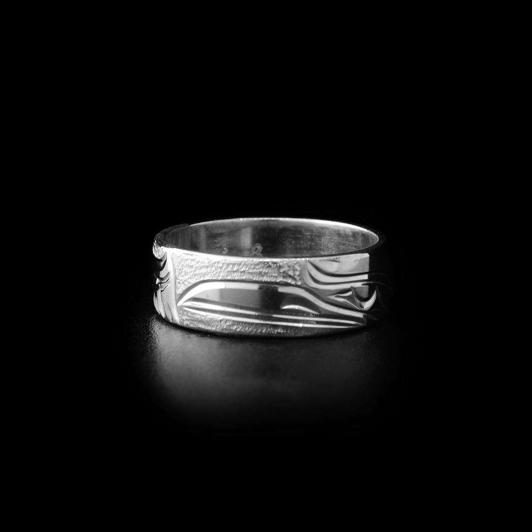 Sterling silver raven ring with hand-carved raven head and background designs. By Kwakwaka’wakw artist Cristiano Bruno.