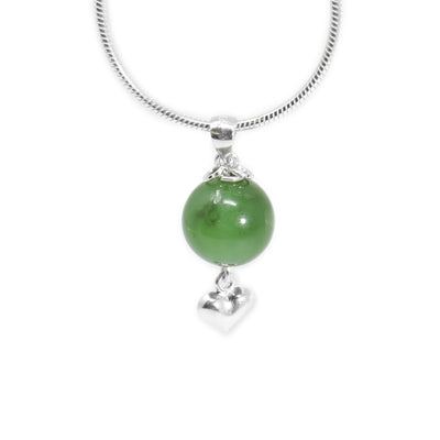 Round BC jade pendant with small silver puff heart adornment hanging below. Two small, silver ring adornments hang off bail. Metal is sterling silver.