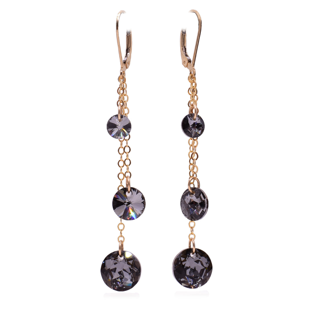 These crystal drop earrings have three gold fill chains of differing lengths attached to the hooks. At the end of these earrings are circle, black Swarovski crystals