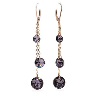 These crystal drop earrings have three gold fill chains of differing lengths attached to the hooks. At the end of these earrings are circle, black Swarovski crystals