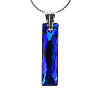 This long crystal pendant is made from Bermuda blue Swarovski crystal that is long, thin and rectangle shaped. The crystal has a deep blue color and hangs from a sterling silver bail that is shaped like a long, upside down triangle with rounded edges.