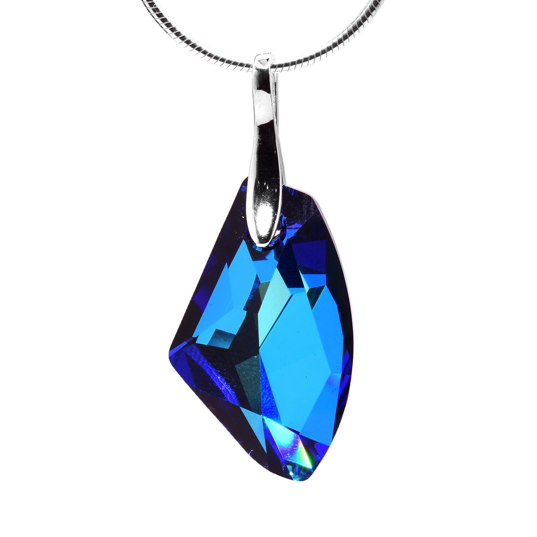 This Bermuda blue crystal pendant is made with a crystal shaped, Swarovski crystal that dangles from sterling silver bail. The crystal hangs sideways and drops down.
