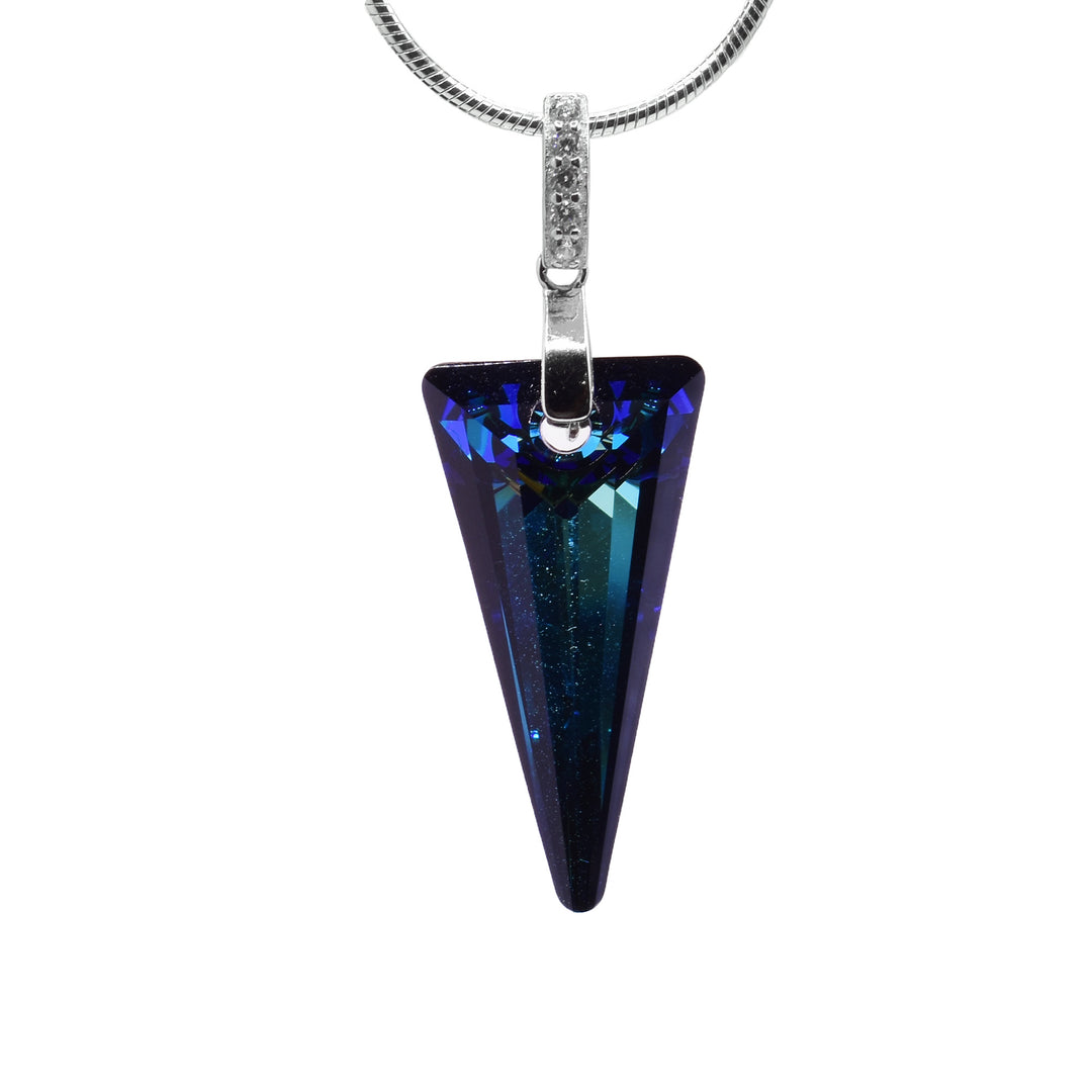 This triangle pendant has an long, triangular and upside down. The pendant is made from Bermuda blue Swarovski crystal and has a deep blue color. The piece dangles from a sterling silver jump ring that has a few cubic zirconia gems placed in the top jump ring..
