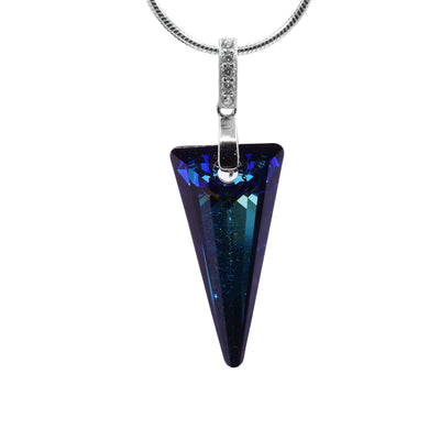 This triangle pendant has an long, triangular and upside down. The pendant is made from Bermuda blue Swarovski crystal and has a deep blue color. The piece dangles from a sterling silver jump ring that has a few cubic zirconia gems placed in the top jump ring..