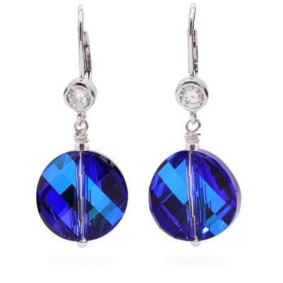 These sterling silver crystal earrings have cubic zirconia gems attached to the hooks. The dangles are circle, blue Swarovski crystals.