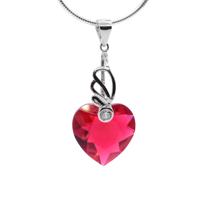 This Swarovski crystal heart pendant is scarlet colored. The pendant dangles from a wide jump ring and drops down from a long, sterling silver charm. There is a fan like designs from this charm at the top of the piece with a cubic zirconia gem held in it. The scarlet crystal below the charm is heart shaped.