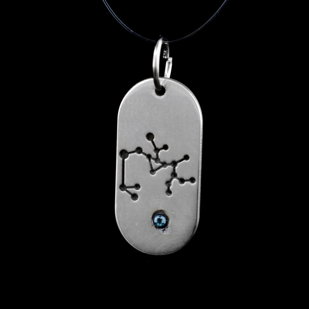 This December zodiac pendant features the December constellation of the Sagittarius. Underneath is a cyan cubic zirconia.