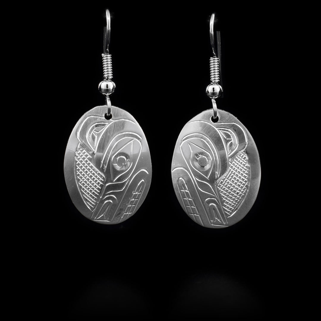 These dangling Wolf earrings are made form sterling silver and have oval shaped hangs. There is are depictions of the Wolf carved into the surface of the hangs.