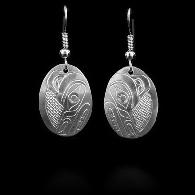 Sterling silver earrings with oval hangs that have the face of the Wolf depicted on them.