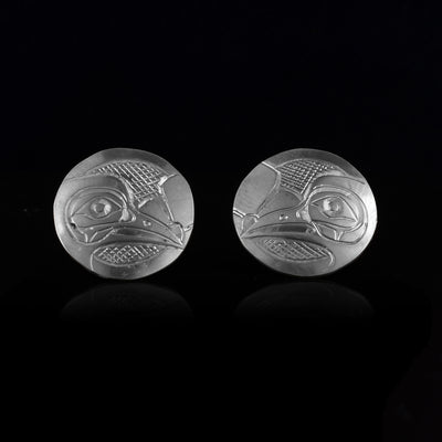 These Hummingbird stud earrings are made from sterling silver and are circle shaped. There are carvings of the side profile of the head of the Hummingbird legend made into the surface of the pieces.