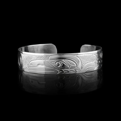 This sterling silver cuff has a single band what a gap in the back. There is a depiction of the Raven carved into the surface of the band.