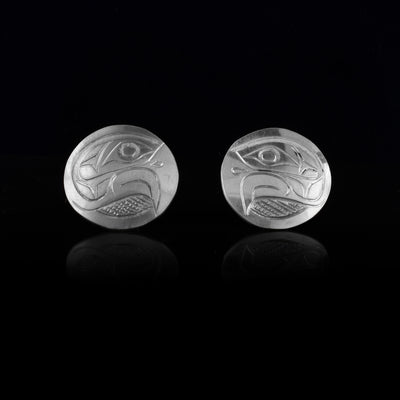 These Eagle stud earrings are made from sterling silver and are circle shaped. There are carvings of the side profile of the head of the Eagle legend made into the surface of the pieces.