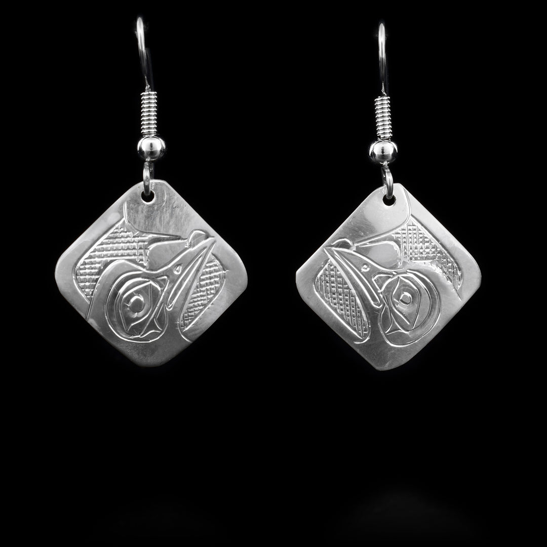 These Hummingbird earrings are made out of sterling silver and have diamond shaped hangs with carvings that depict the Hummingbirds etched into them.