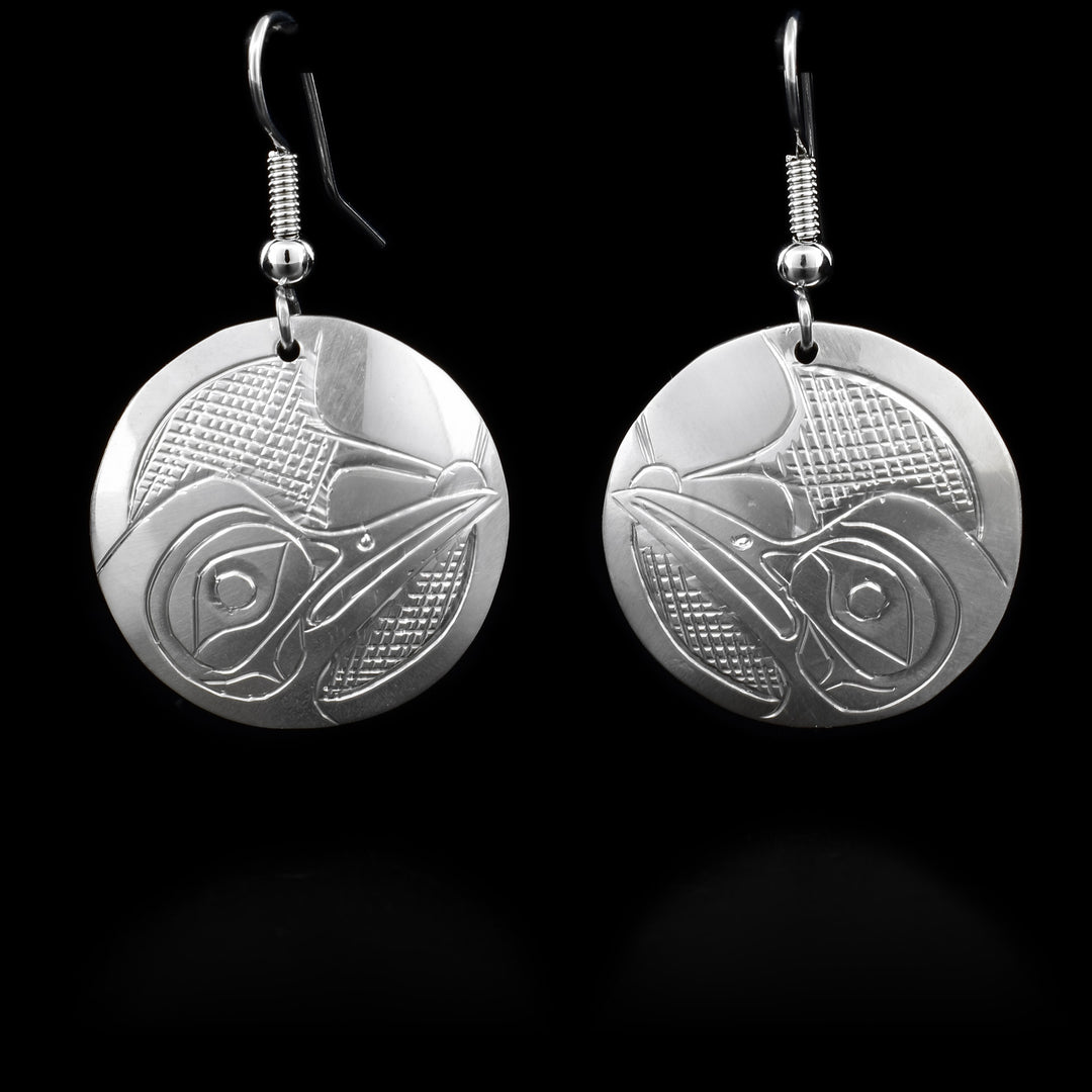 Sterling silver dangle Hummingbird earrings that have a round hang. The hang depicts the face of the Hummingbird.
