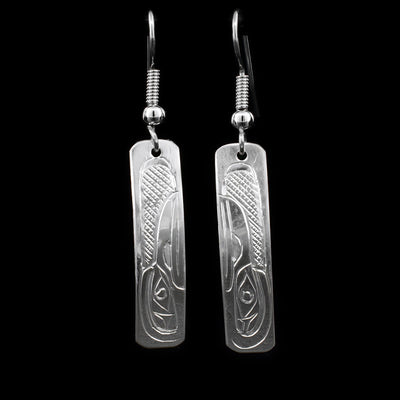 These sterling silver earrings have hooks, with rectangular hangs that depict the face of the Raven.