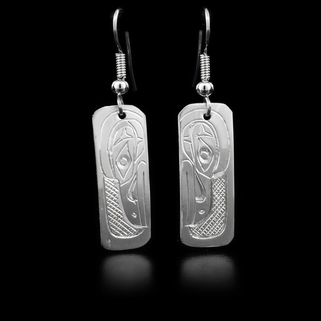 These sterling silver dangle earrings have rectangular hangs with depictions of the Raven carved into them.