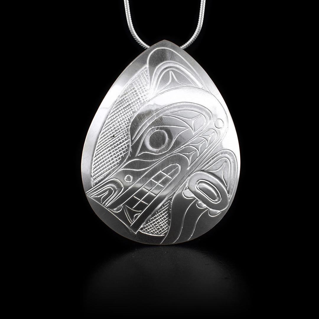 This sterling silver pendant is shaped like a wide teardrop. It has the Wolf etched into it.