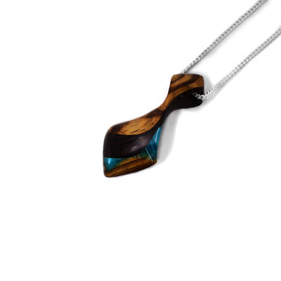 Blue side of pendant. Tie-shaped pendant made of wood with black stripes. Shimmering blue design on bottom. Sterling silver chain included.