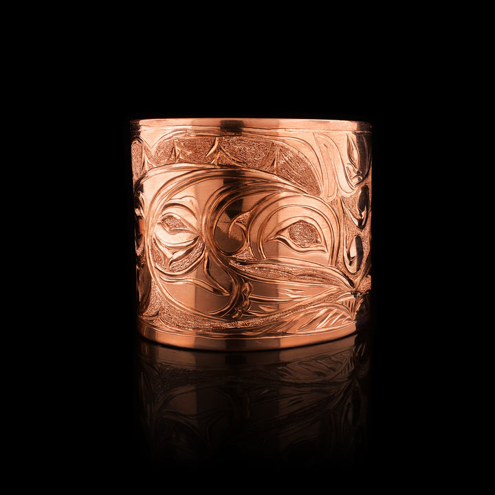 Copper Double Hummingbird and Moon Bracelet by Kwakwaka'wakw artist Cristiano Bruno. This handcrafted cuff features the legend of two hummingbirds touching beaks, set against a beautifully engraved moon on a polished 2 inch wide copper band.