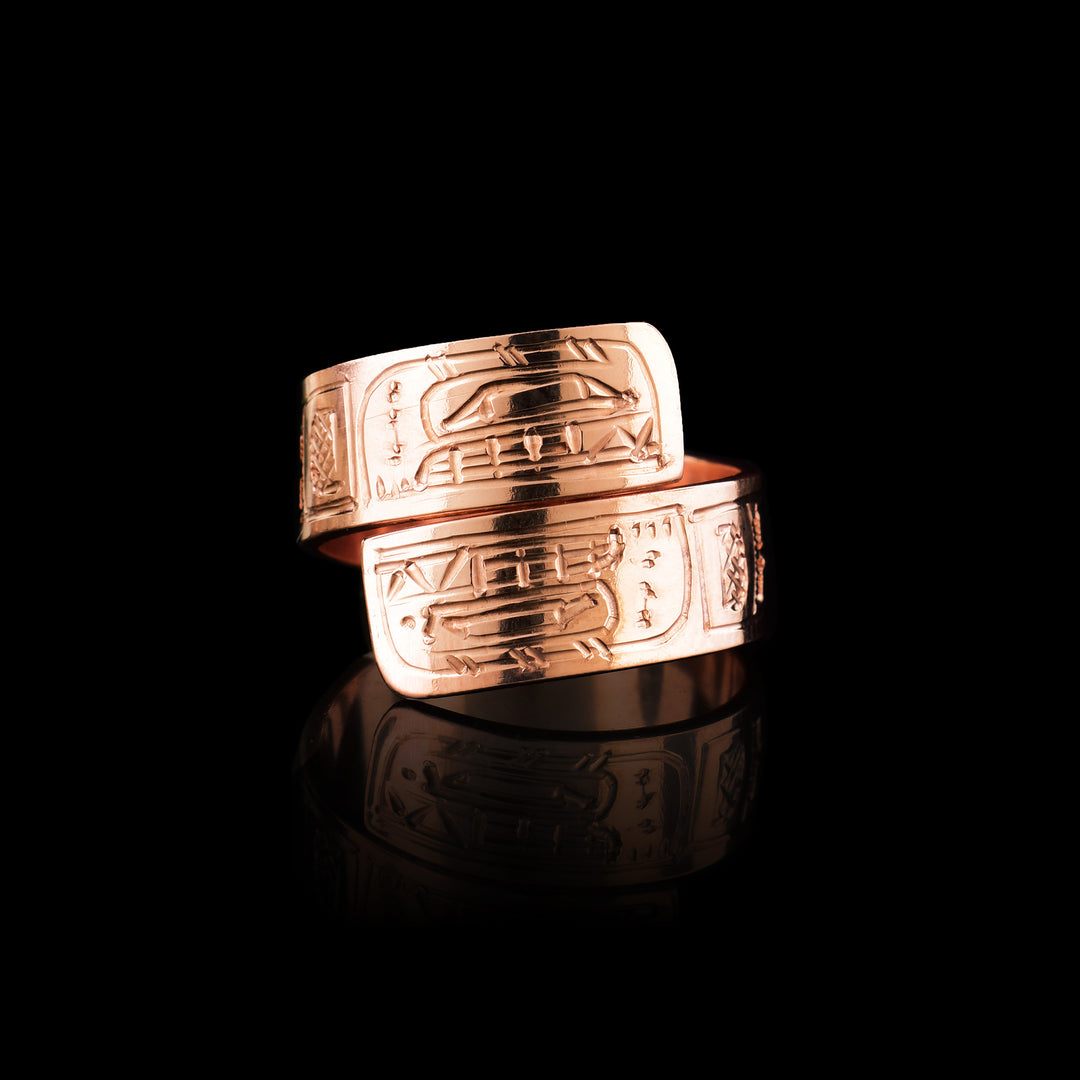 This unique copper ring has a single, thin band that wraps around the finger twice. There are gorgeous depictions of the Orca carved into the surface of the band.
