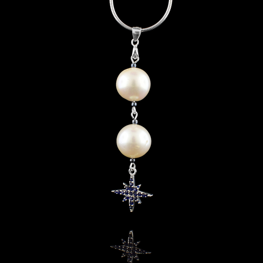 Double pearl drop with a blue cubic zirconia celestial star