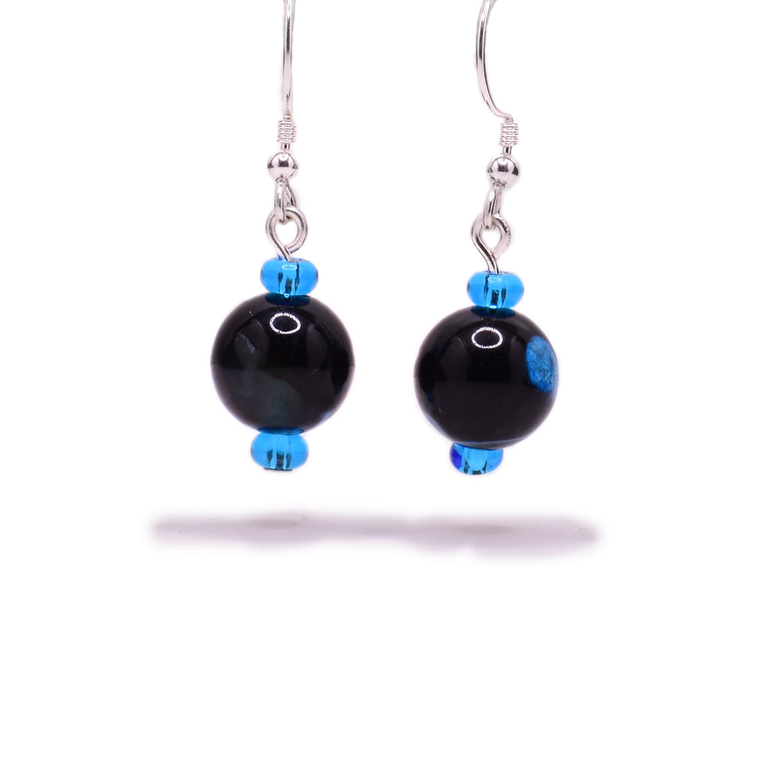 Round, black dyed agate beads, each with a blue dot and little blue glass beads above and below. Sterling silver hooks.