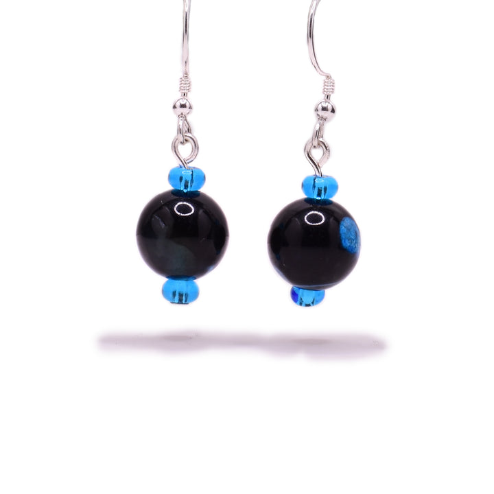 Round, black dyed agate beads, each with a blue dot and little blue glass beads above and below. Sterling silver hooks.