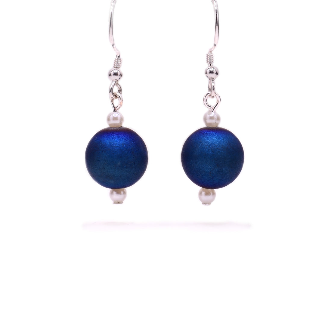 Round, dark blue dyed agate beads with little white pearl beads above and below. Sterling silver hooks.