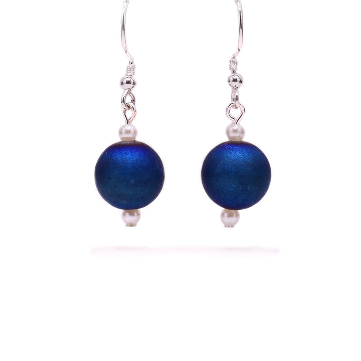 Round, dark blue dyed agate beads with little white pearl beads above and below. Sterling silver hooks.