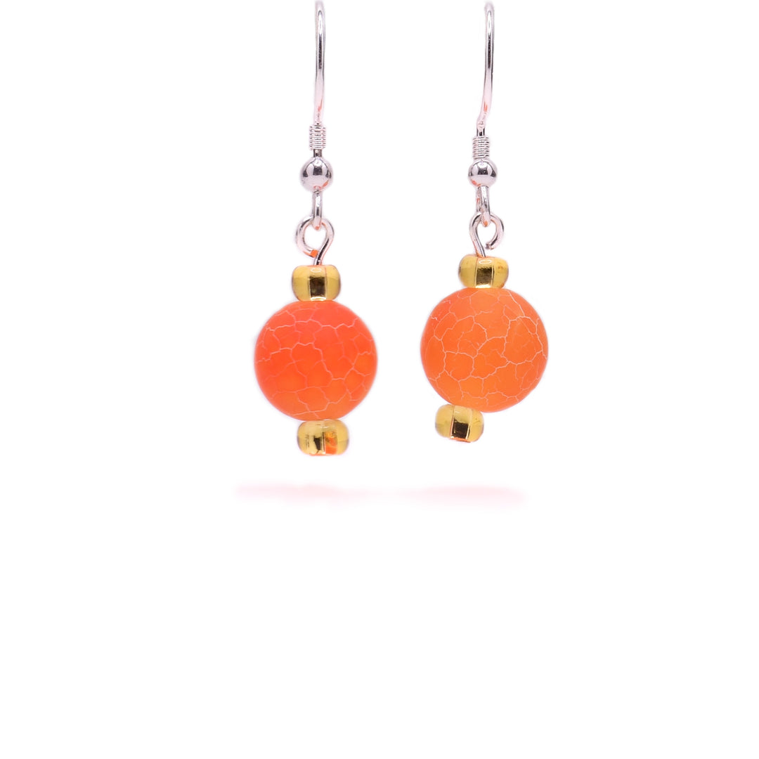 Round, orange dyed agate beads with cracked appearance and little yellow glass beads above and below. Sterling silver hooks.