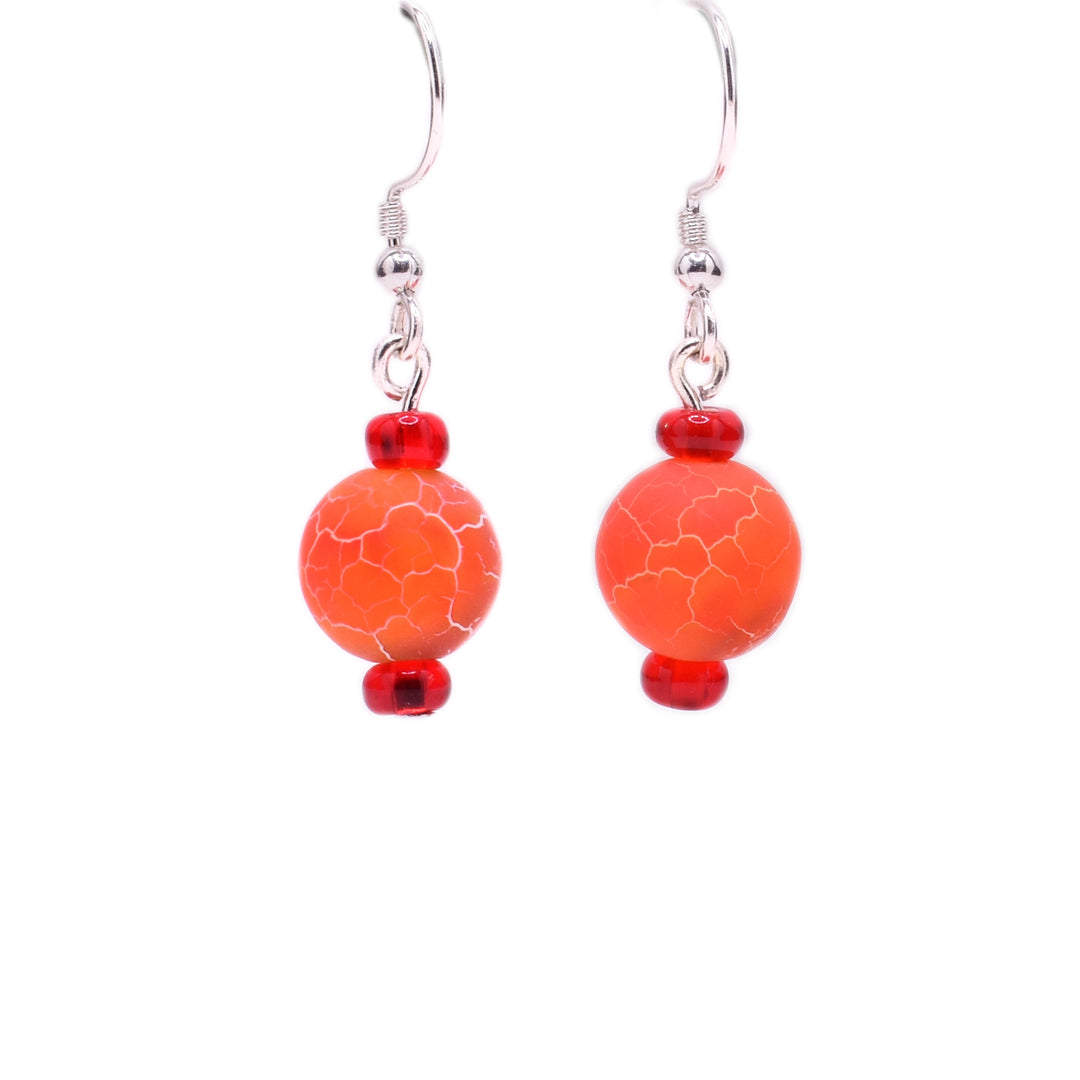 Round, orange dyed agate beads with cracked appearance and little red glass beads above and below. Sterling silver hooks.