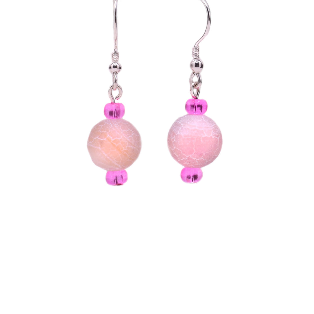 Round, pink dyed agate beads with cracked appearance and little pink glass beads above and below. Sterling silver hooks.