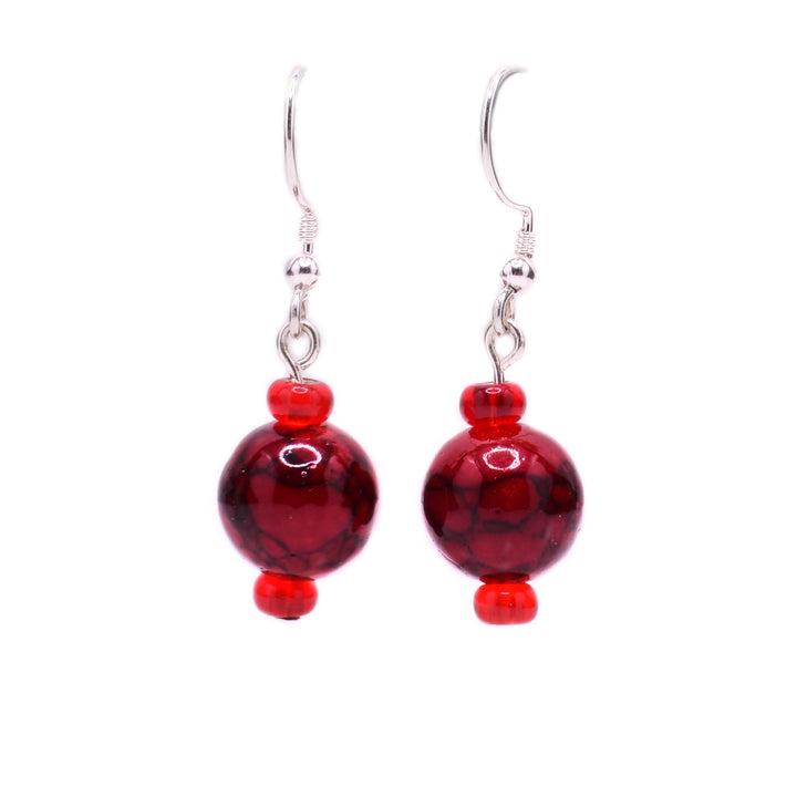 Round, dark red dyed quartzite beads with little red glass beads above and below. Sterling silver hooks.
